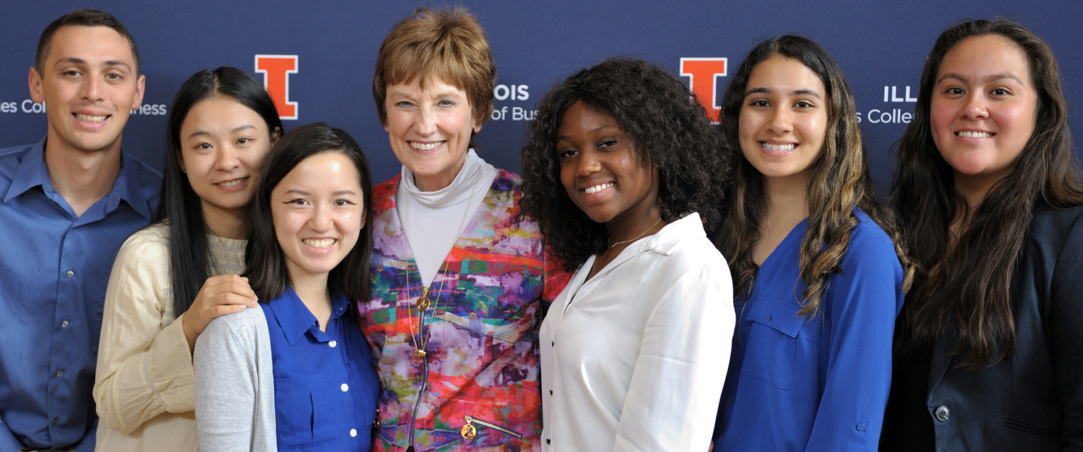 A group of current students pose for a picture with a Gies alumna.